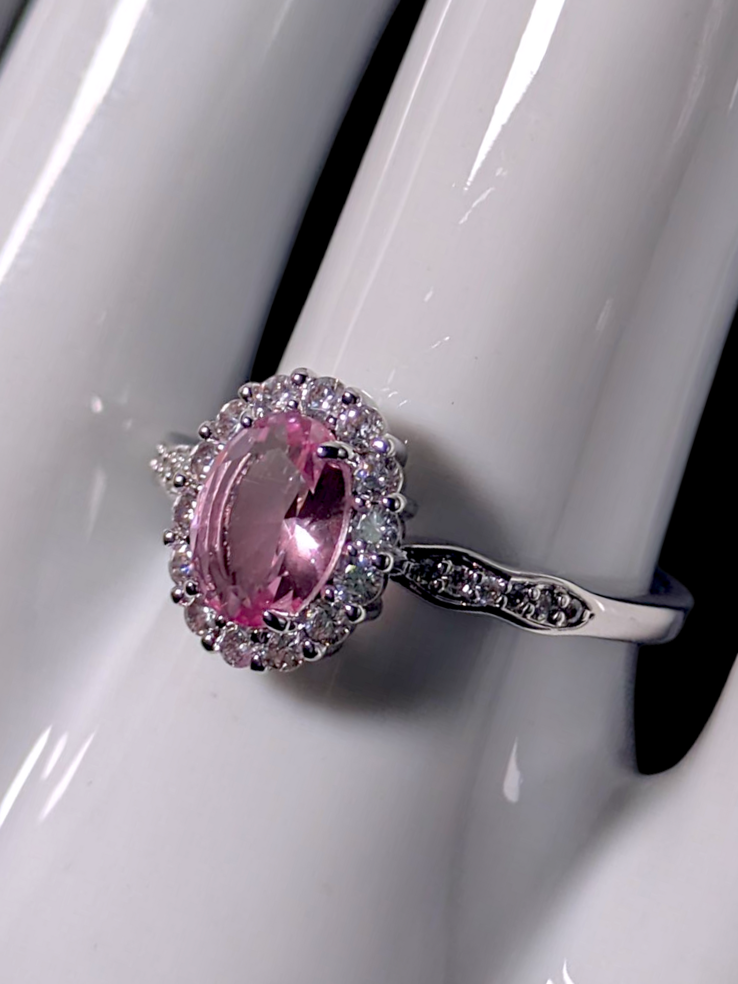 Vintage Inspired Oval Cut Simulated Pink Diamond Solitaire with Simulated Diamond Halo Wavy Silver Toned Ring