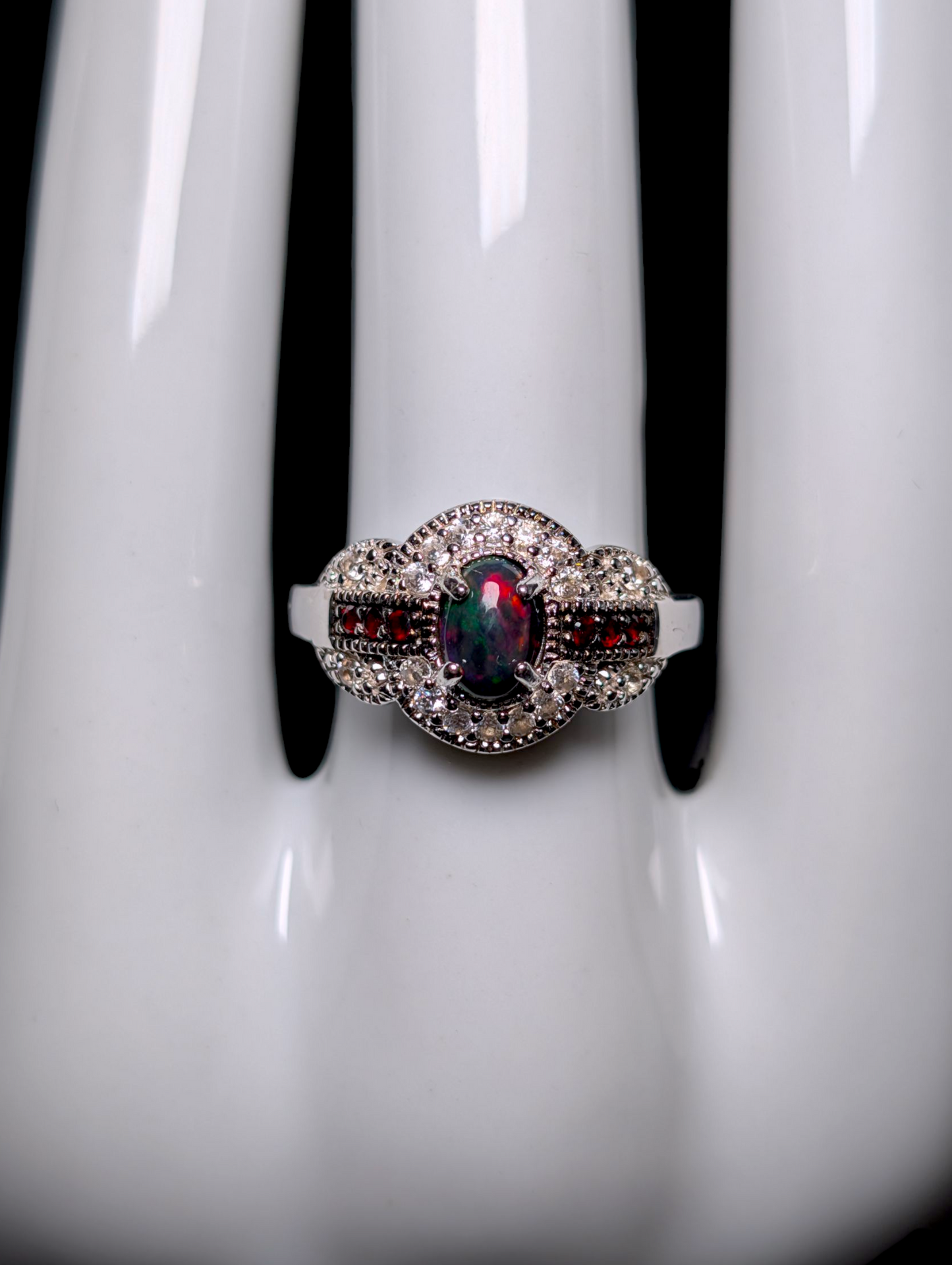 Vintage Cabochon Oval Cut Genuine Black Opal with Garnet Accent Stones and White Topaz Halo Sterling Silver Ring
