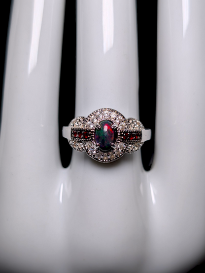 Vintage Cabochon Oval Cut Genuine Black Opal with Garnet Accent Stones and White Topaz Halo Sterling Silver Ring