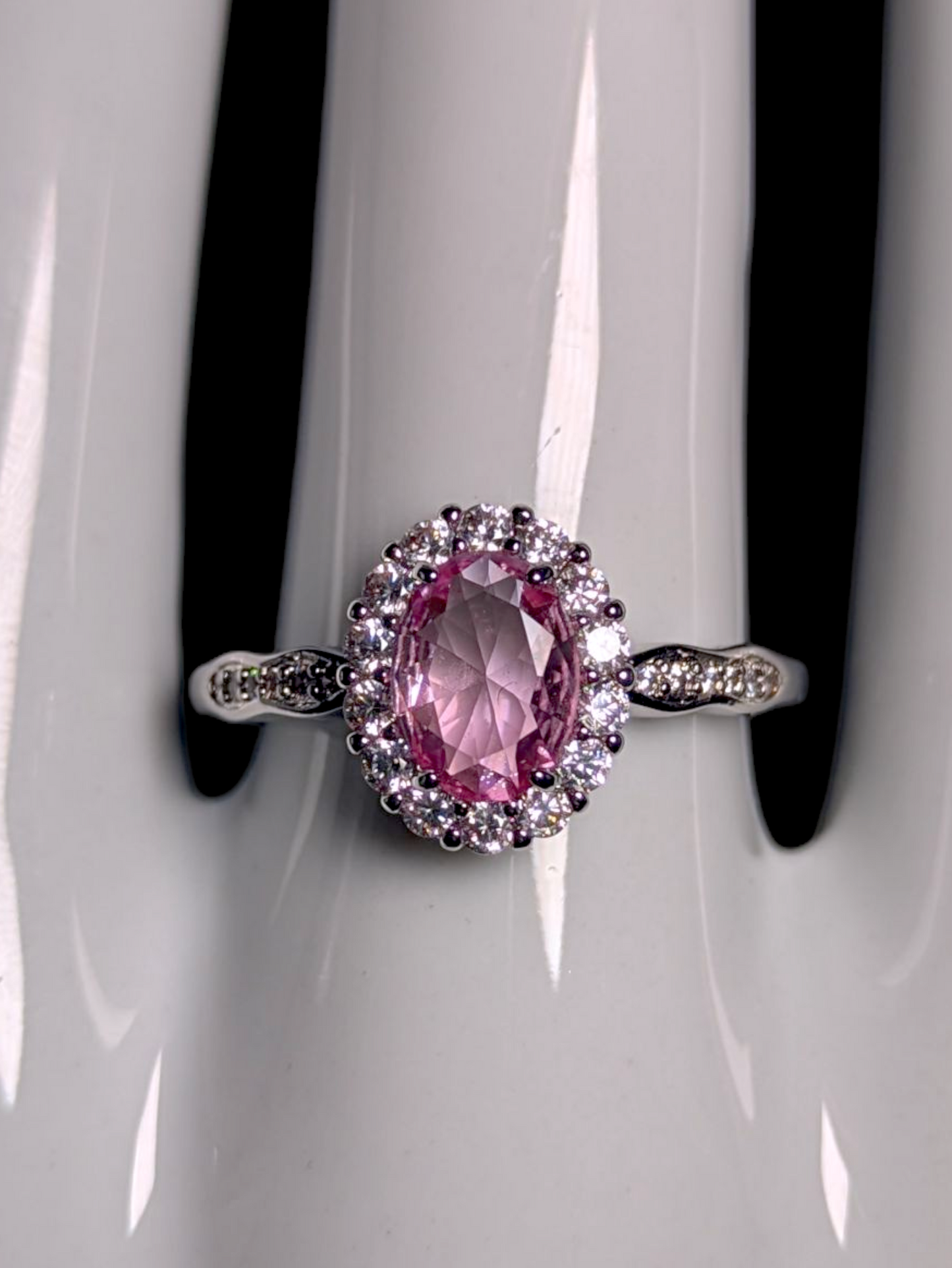 Vintage Inspired Oval Cut Simulated Pink Diamond Solitaire with Simulated Diamond Halo Wavy Silver Toned Ring