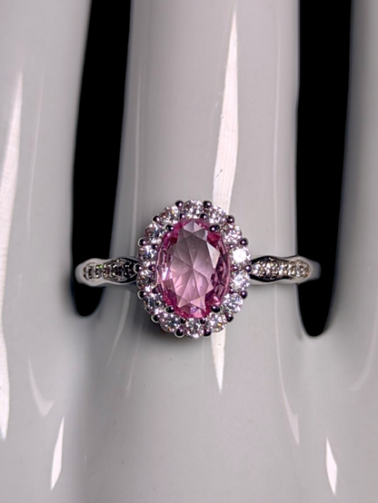 Vintage Inspired Oval Cut Simulated Pink Diamond Solitaire with Simulated Diamond Halo Wavy Silver Toned Ring