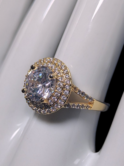 Vintage Inspired Round Cut Simulated Diamond Solitaire with Simulated Diamond Double Halo and Accented Band Gold Toned Vacation Ring