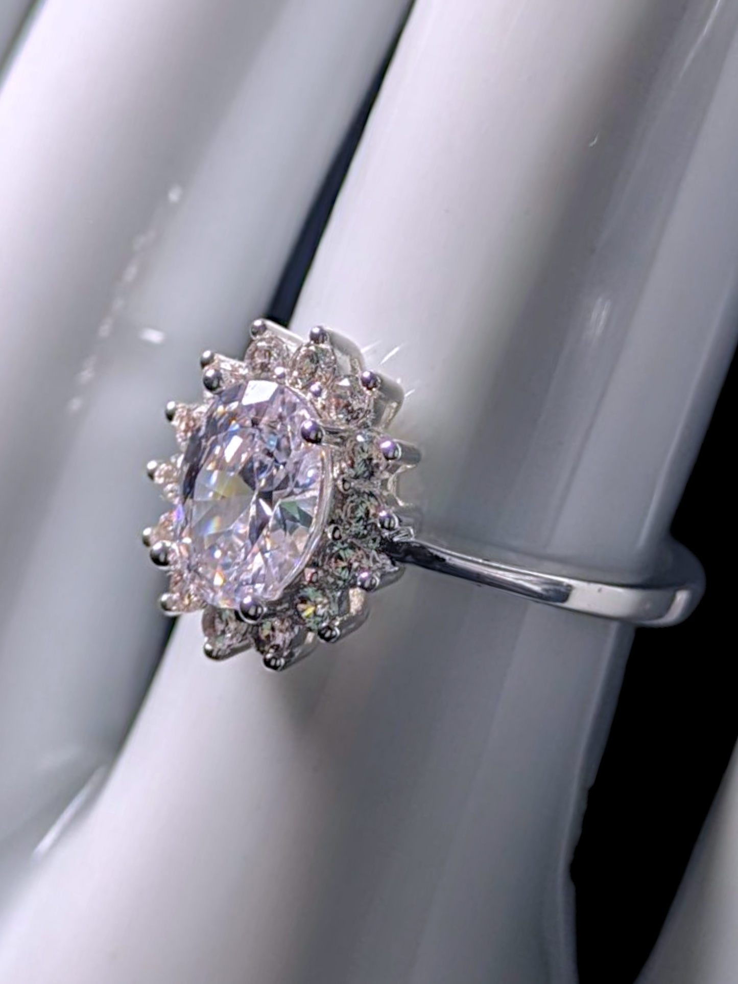 Vintage Inspired Oval Cut Simulated Diamond Solitaire with Simulated Diamond Sunburst Halo Silver Toned Vacation Ring