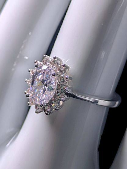 Vintage Inspired Oval Cut Simulated Diamond Solitaire with Simulated Diamond Sunburst Halo Silver Toned Vacation Ring