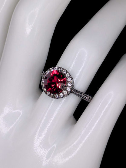Vintage Inspired Round Single Cut Simulated Ruby Solitaire with Simulated Diamond Halo on Intricate Mount Oxidized Silver Toned Ring