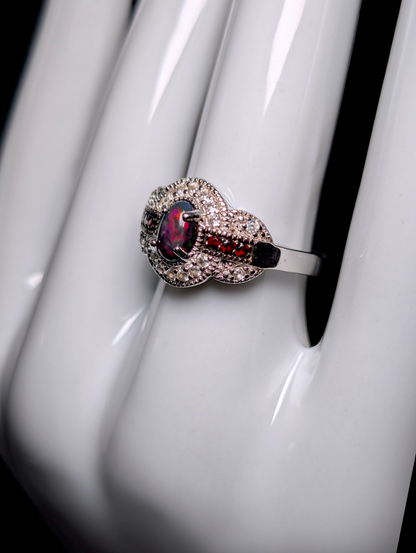 Vintage Cabochon Oval Cut Genuine Black Opal with Garnet Accent Stones and White Topaz Halo Sterling Silver Ring