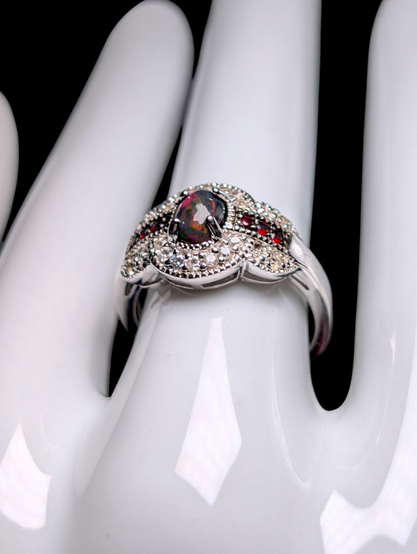 Vintage Cabochon Oval Cut Genuine Black Opal with Garnet Accent Stones and White Topaz Halo Sterling Silver Ring