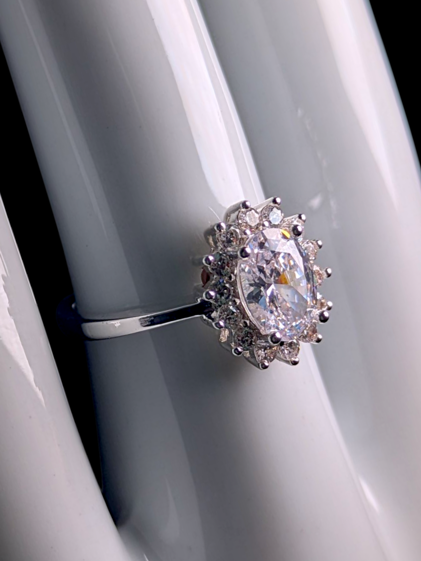 Vintage Inspired Oval Cut Simulated Diamond Solitaire with Simulated Diamond Sunburst Halo Silver Toned Vacation Ring