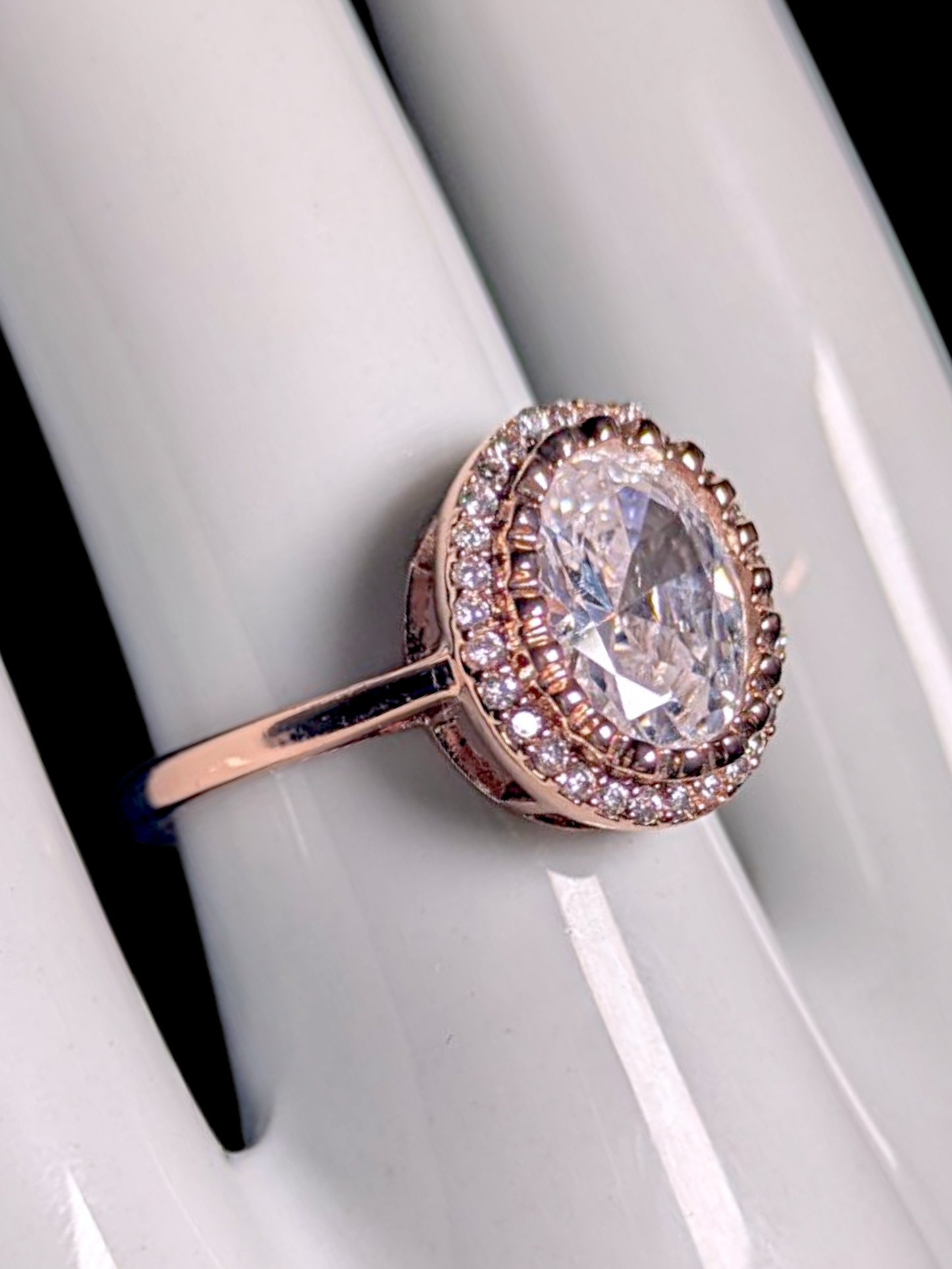 Vintage Inspired Simulated Diamond Solitaire with Simulated Diamond Halo with Asymmetrical Designed Mount Rose Gold Toned Ring