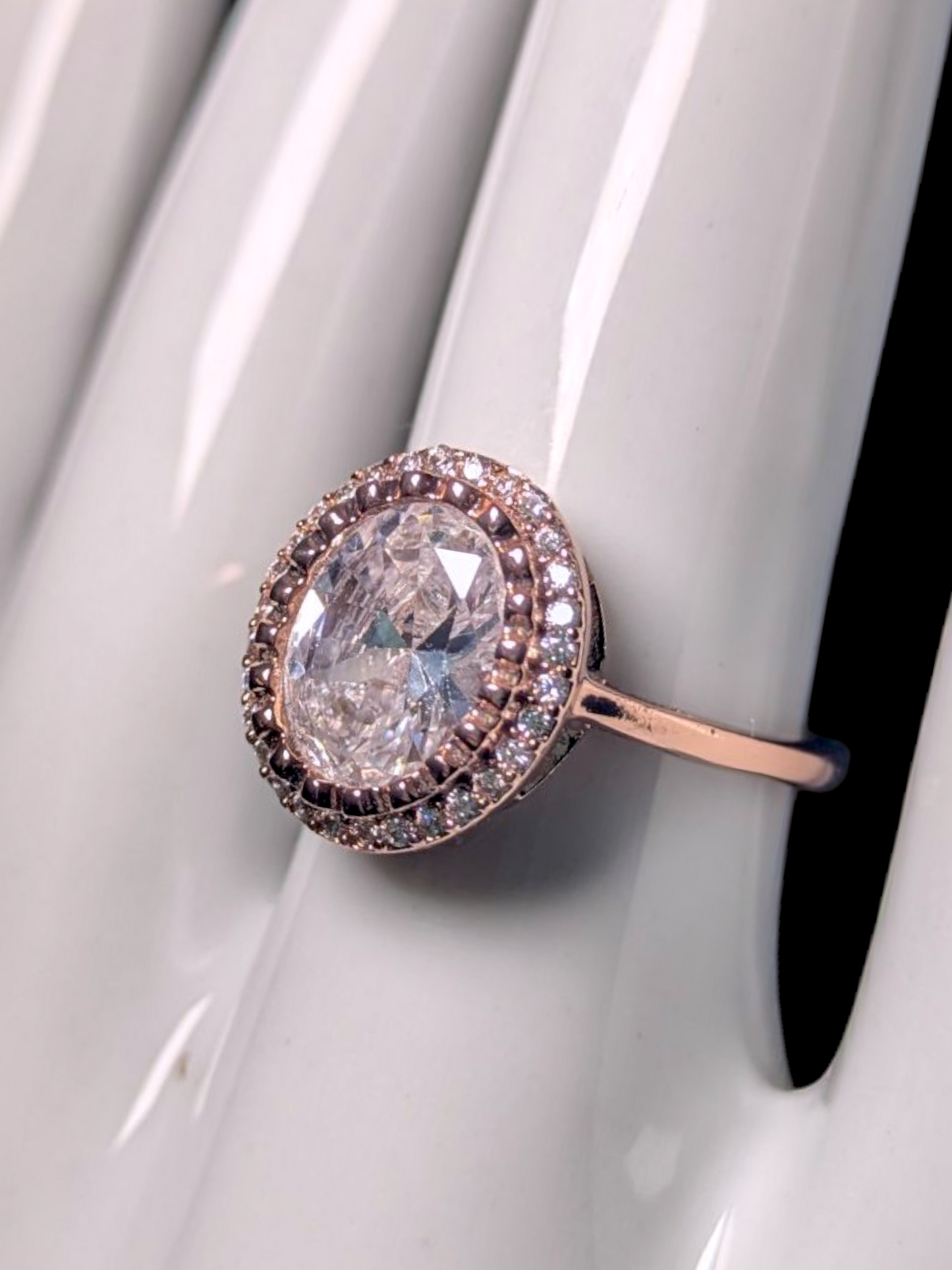 Vintage Inspired Simulated Diamond Solitaire with Simulated Diamond Halo with Asymmetrical Designed Mount Rose Gold Toned Ring