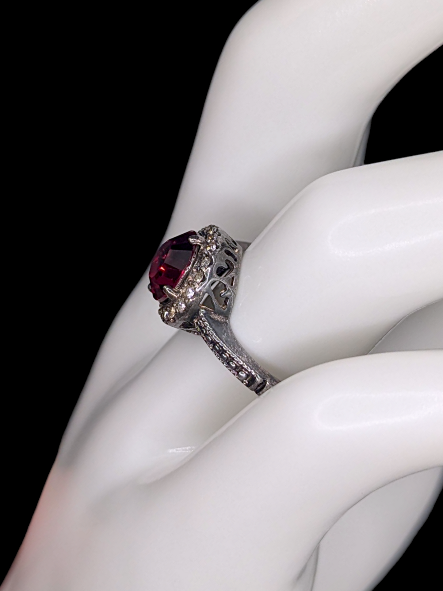 Vintage Inspired Round Single Cut Simulated Ruby Solitaire with Simulated Diamond Halo on Intricate Mount Oxidized Silver Toned Ring