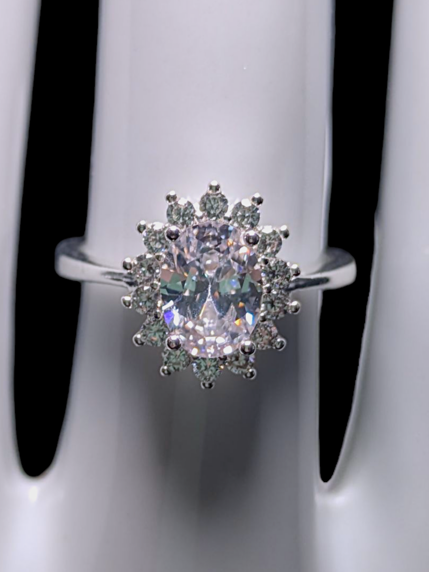 Vintage Inspired Oval Cut Simulated Diamond Solitaire with Simulated Diamond Sunburst Halo Silver Toned Vacation Ring